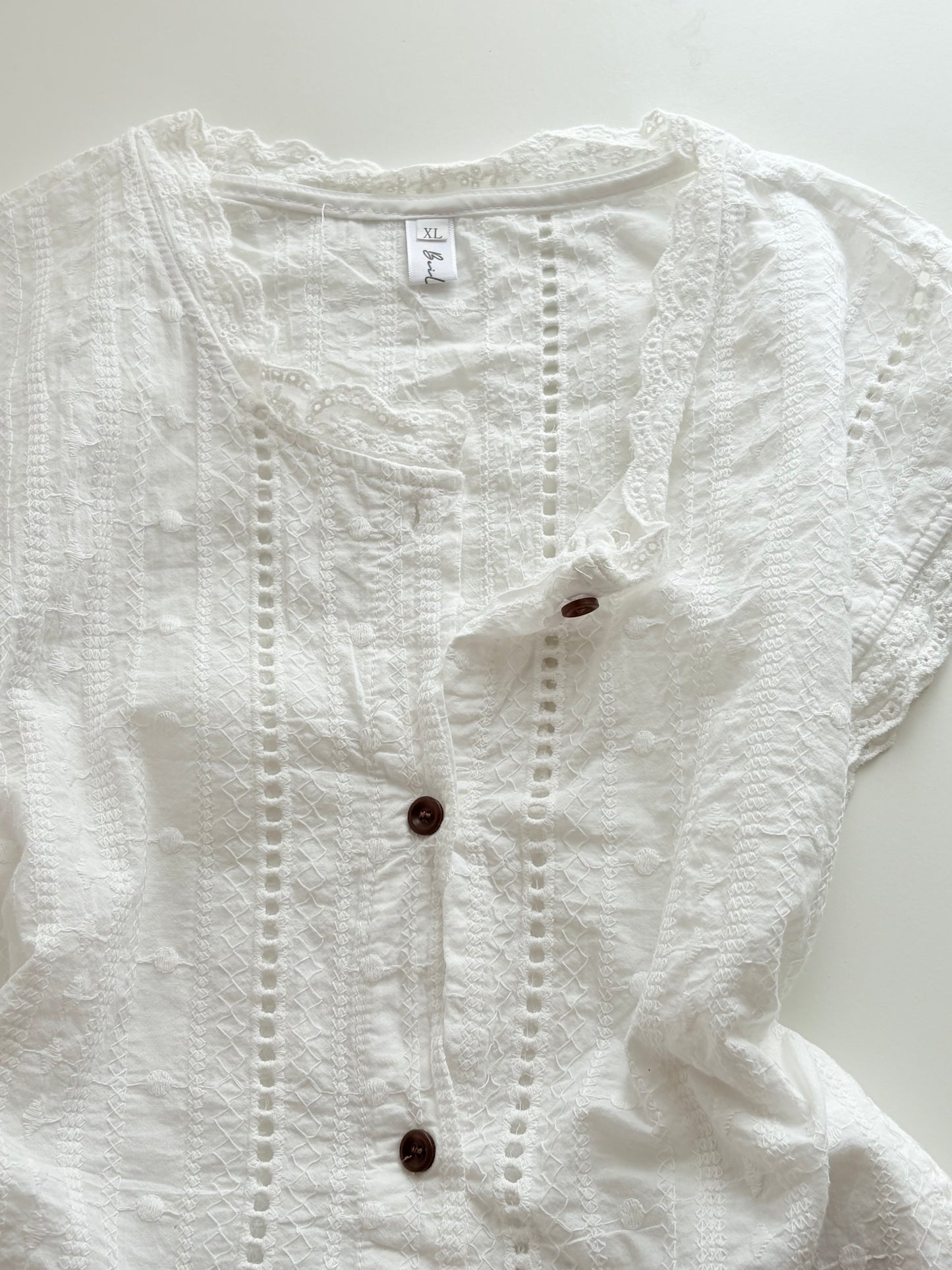 White buttoned top